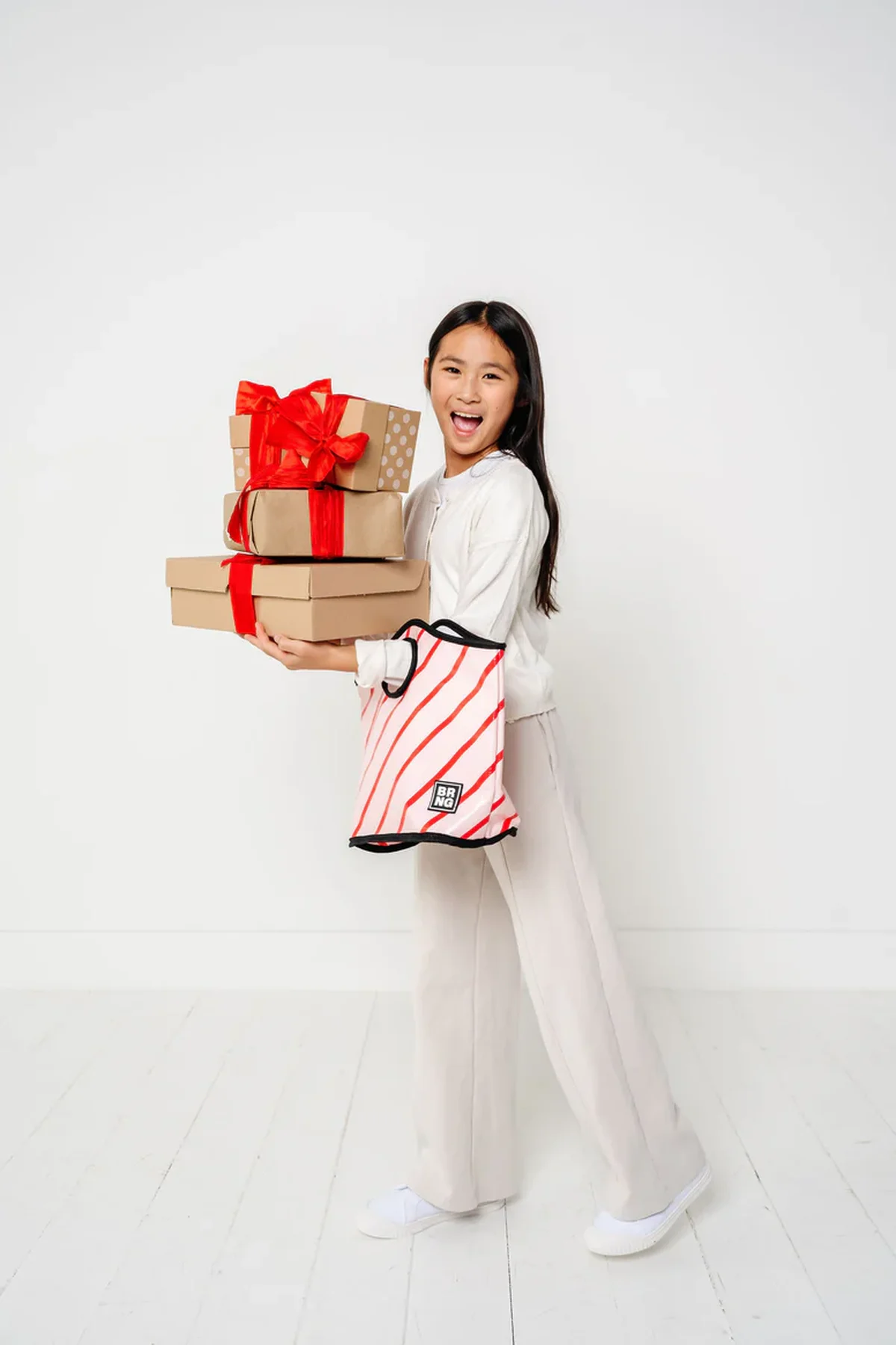 BRNG tote bags in holiday prints being carried