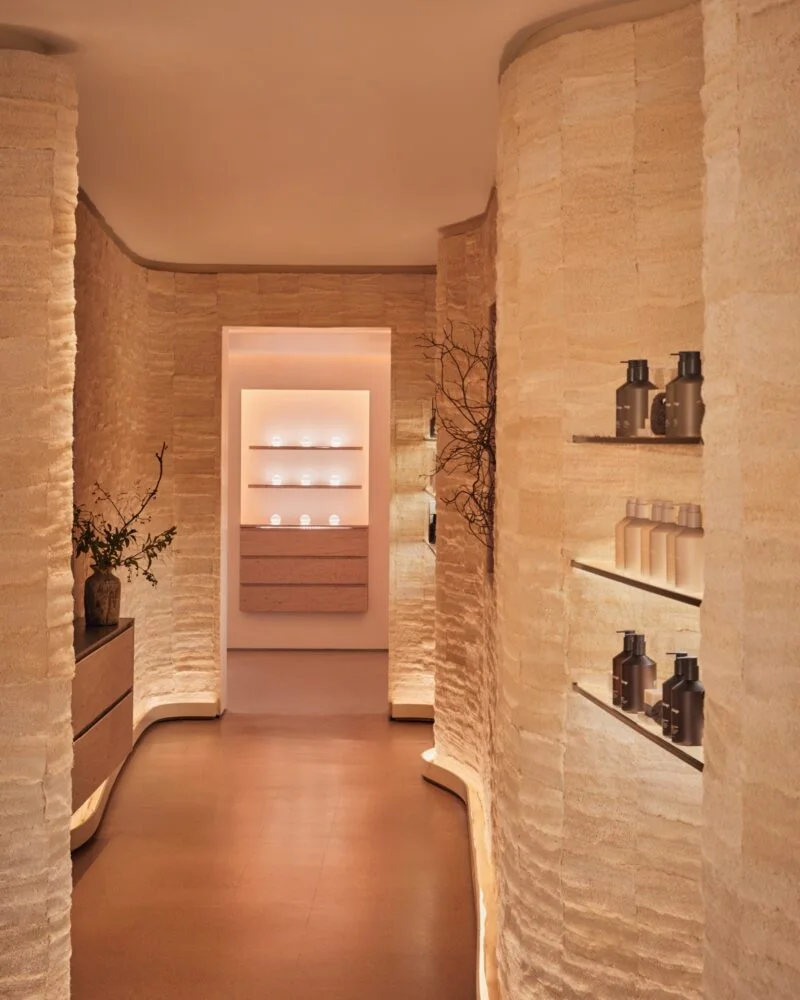 Warm minimalist spa-like corridor with textured stone walls