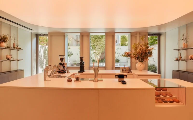 Minimalist café bar with pastries and floral arrangements
