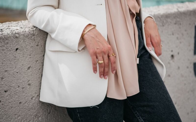 Woman wearing a collarless cutaway blazer over wide-leg pants