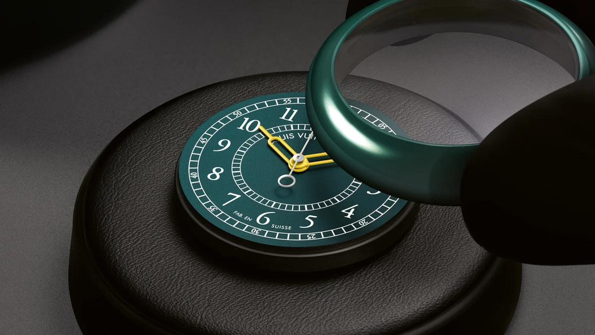 Green ceramic Louis Vuitton Monterey watch displayed on a black stand